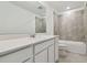 Modern bathroom with white vanity, bathtub, and tiled shower at 12733 Wanderlust Pl, Parrish, FL 34219