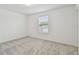 Well-lit bedroom with grey carpet and window coverings at 12733 Wanderlust Pl, Parrish, FL 34219