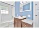 Updated bathroom with white subway tile and wood vanity at 6921 Onyx N Dr, St Petersburg, FL 33702