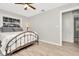 Bedroom with flamingo bedding, ceiling fan, and wood-look floors at 6921 Onyx N Dr, St Petersburg, FL 33702