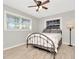 Bedroom with flamingo bedding, ceiling fan, and wood-look floors at 6921 Onyx N Dr, St Petersburg, FL 33702