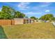 Ranch home with a well-maintained lawn and wooden fence at 6921 Onyx N Dr, St Petersburg, FL 33702