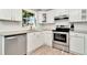 White cabinets, granite countertops, stainless steel appliances in kitchen at 6921 Onyx N Dr, St Petersburg, FL 33702