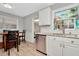 Modern kitchen with white cabinets, granite countertops, and stainless steel appliances at 6921 Onyx N Dr, St Petersburg, FL 33702