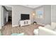 Living room with white couch, TV stand and wood flooring at 6921 Onyx N Dr, St Petersburg, FL 33702