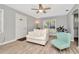 Living room with white couch, mint chair and ceiling fan at 6921 Onyx N Dr, St Petersburg, FL 33702