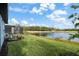 Spacious backyard with lush lawn and pond view at 3778 Maxwell Park Dr, Sun City Center, FL 33573