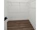 Walk-in closet with wire shelving and dark brown flooring at 3778 Maxwell Park Dr, Sun City Center, FL 33573