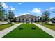 Community clubhouse with cornhole, benches, and landscaping at 3778 Maxwell Park Dr, Sun City Center, FL 33573