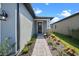 House exterior showcasing a walkway to the front door and landscaping at 3778 Maxwell Park Dr, Sun City Center, FL 33573