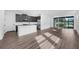 Modern kitchen featuring dark cabinetry, white countertops, and island at 3778 Maxwell Park Dr, Sun City Center, FL 33573