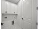 Laundry room with white cabinets and marble floor at 3778 Maxwell Park Dr, Sun City Center, FL 33573