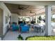 Relaxing poolside patio with seating and fans at 3778 Maxwell Park Dr, Sun City Center, FL 33573