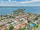 Wide aerial view of a coastal community nestled along the water, showcasing neighborhood streets and waterways at 186 45Th Ave, St Pete Beach, FL 33706