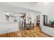 Light-filled hallway with wood floors, offering views of the kitchen and a bedroom at 20 Summerwinds Ln, Oldsmar, FL 34677