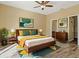 Bright bedroom with a king-size bed and wood floors at 5723 Autumn Shire Dr, Zephyrhills, FL 33541