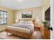Large main bedroom with wood bed frame, neutral color scheme, and plenty of natural light at 5723 Autumn Shire Dr, Zephyrhills, FL 33541