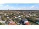 Expansive aerial view capturing the neighborhood's homes with a scenic cityscape in the distance at 5006 W San Miguel St, Tampa, FL 33629
