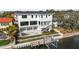 Aerial view of a backyard showcasing a waterfront, private dock, a refreshing pool, and well-manicured landscaping at 5006 W San Miguel St, Tampa, FL 33629