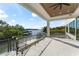 Expansive covered balcony with a ceiling fan offers stunning views of the waterfront and boat dock at 5006 W San Miguel St, Tampa, FL 33629