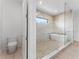 Modern bathroom with a soaking tub behind a glass shower enclosure at 5006 W San Miguel St, Tampa, FL 33629