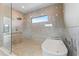 Luxurious bathroom featuring a soaking tub, walk-in shower, and upscale fixtures at 5006 W San Miguel St, Tampa, FL 33629