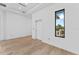 Bedroom with wood floors and modern window showcasing palm tree views at 5006 W San Miguel St, Tampa, FL 33629
