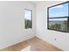 Bright bedroom features hardwood floors and two windows offering a peaceful view at 5006 W San Miguel St, Tampa, FL 33629
