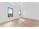 Clean bedroom with large windows and hardwood floors, offering a minimalist aesthetic at 5006 W San Miguel St, Tampa, FL 33629