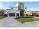 Stunning two-story home boasting a manicured lawn, a convenient two-car garage, and a lushly landscaped yard at 5006 W San Miguel St, Tampa, FL 33629