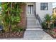 Inviting front entrance showcases a modern staircase, landscaping and a contemporary design at 5006 W San Miguel St, Tampa, FL 33629
