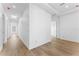 Long hallway with hardwood floors and modern white trim and doors at 5006 W San Miguel St, Tampa, FL 33629