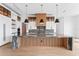 Luxurious kitchen boasts a central island with striking stone countertops and designer pendant lighting at 5006 W San Miguel St, Tampa, FL 33629