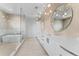 Contemporary bathroom featuring a soaking tub, modern lighting, dual vanities, and elegant tiling at 5006 W San Miguel St, Tampa, FL 33629