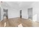 The expansive main bedroom features a ceiling fan, hardwood floors, and doorway to ensuite bathroom and walk-in closet at 5006 W San Miguel St, Tampa, FL 33629