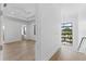 Bright main bedroom with hardwood floors and view to stairs and window with views of neighborhood at 5006 W San Miguel St, Tampa, FL 33629