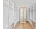 Spacious walk-in closet with custom shelving, drawers, and mirrored cabinets, providing ample storage at 5006 W San Miguel St, Tampa, FL 33629