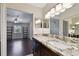 Bathroom with granite counters, dark wood cabinets and mirrors at 8693 Bardmoor Blvd # 308B, Seminole, FL 33777