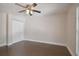 Well lit bedroom with hardwood floors, a ceiling fan and bright window at 8693 Bardmoor Blvd # 308B, Seminole, FL 33777