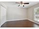 Cozy bedroom with hardwood floors, ceiling fan, closet and a bright window at 8693 Bardmoor Blvd # 308B, Seminole, FL 33777