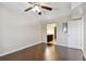 Bedroom featuring hardwood floors, a ceiling fan, and an open doorway to a bathroom at 8693 Bardmoor Blvd # 308B, Seminole, FL 33777
