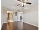 Bedroom featuring hardwood floors, a ceiling fan, and an open doorway to a bathroom at 8693 Bardmoor Blvd # 308B, Seminole, FL 33777