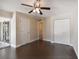 Bedroom featuring hardwood floors, a ceiling fan, closet, and sliding glass doors to the balcony at 8693 Bardmoor Blvd # 308B, Seminole, FL 33777
