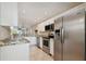 Modern kitchen featuring stainless steel appliances, granite countertops and white cabinetry at 8693 Bardmoor Blvd # 308B, Seminole, FL 33777