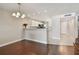 Bright living room featuring hardwood floors, an elegant chandelier, and a kitchen with modern amenities at 8693 Bardmoor Blvd # 308B, Seminole, FL 33777