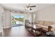 Cozy living room boasts natural light from a sliding glass door leading to a balcony with neighborhood views at 8693 Bardmoor Blvd # 308B, Seminole, FL 33777