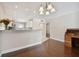 Open-concept living space with stylish lighting, desk and hardwood flooring at 8693 Bardmoor Blvd # 308B, Seminole, FL 33777
