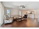 Spacious living room flows seamlessly to a modern kitchen, with a cozy seating area and a ceiling fan at 8693 Bardmoor Blvd # 308B, Seminole, FL 33777
