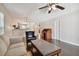 Open-concept living room provides ample space, showcasing hardwood floors, a ceiling fan, and kitchen access at 8693 Bardmoor Blvd # 308B, Seminole, FL 33777