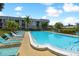 Community pool with lounge chairs and lush landscaping at 8693 Bardmoor Blvd # 308B, Seminole, FL 33777
